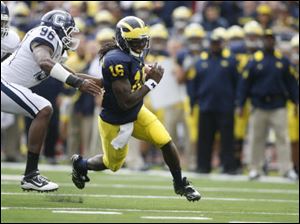 Michigan coach Rich Rodriguez said star quarterback Denard Robinson (16) should be available for Saturday's match against Penn State.