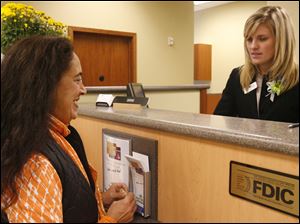 BIZ bank25p  Therese (cq) King, of Toledo, left, in the new branch with Sarah Florian, right. A new branch downtown for Fifth Third, replacing one they closed a block away a year ago, in Toledo, Ohio on October 25, 2010. Jetta Fraser/The Blade