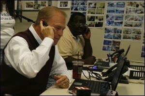 Gov. Ted Strickland joins volunteer Luther Mayfield of Toledo to make some calls to prospective voters during the governor's stop at the Democratic Party call center in East Toledo. 
