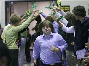 Twin lines of teachers offered celebratory high-fives to the students, including fourth grader Devyn-Vaughn Carmony.