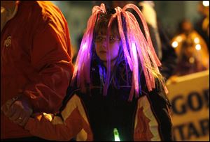 Alexis Nowak, 10, added to the festive atmosphere with a wig of pink glow sticks.