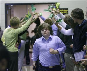 Twin lines of teachers offered celebratory high-fives to the students, including fourth grader Devyn-Vaughn Carmony.