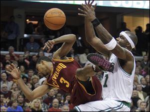 Cleveland's Ramon Sessions, left, is fouled by Boston's Jermaine O'Neal in the fourth quarter. The Cavaliers defeated the Celtics one night after Boston beat LeBron James and the Heat.