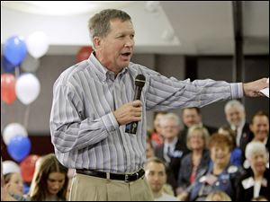 John Kasich, GOP gubernatorial candidate, talks to supporters in Strongsville, Ohio, where he was endorsed by retiring Sen. George Voinovich and former Browns quarterback Bernie Kosar.