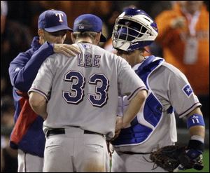 Rangers pitching coach Mike Maddux, left, talks with Cliff Lee, who allowed seven runs (six earned) before leaving in the fifth inning.