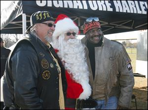 CTY toyrun08p   Michael Wenzel (cq), of Toledo, founder and organizer of the 21st Annual Bikers of N.W. Ohio Toy Run, left, Santa Claus, of the North Pole-and beyond-toy run, and Toledo mayor Mike Bell. Santa Claus, Michael Wenzel (cq), of Toledo, founder and organizer of the 21st Annual Bikers of N.W. Ohio Toy Run, and Toledo Mayor Mike Bell lead about 1500 riders from the Toledo Speedway inToledo to the Lucas County Recreation Center in Maumee, Ohio on a benefit ride for children of Harbor. The ride was escorted by Lucas County Sheriff Department motorcycle officers who donated their time for the benefit. "Thank you to everyone who came out for the kids", says Jean Drees (cq), marketing director for Harbor, noting that Harbor is the largest provider of mental health services for children in northwest Ohio. The current poor economic situation in the area has added to the community's needs, as so many lives have been turned "upside down". Everybody needs help at some point, says Drees. Over the half dozen of so years which Harbor has been the Run's beneficiary, the organization has received net proceeds close to $80,000.  With the cash donations which they received today, Harbor tries to make the most from it by bargaining with local stores. Jetta Fraser/The Blade