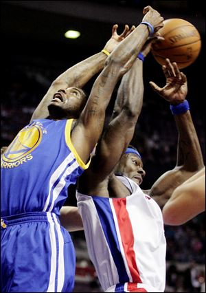 Detroit's Ben Wallace, right, steals a rebound from Golden State's Dorell Wright in the first half. The Pistons won their last home game before a four-game, six-day road trip out west.