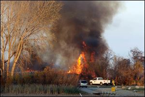Crews from five fire departments were on the scene but could not enter the marsh area. Smoke was visible for miles, and flames leapt into the sky, attracting numerous spectators. 
