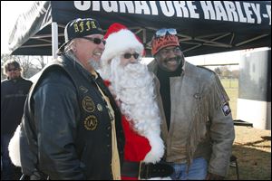 CTY toyrun08p   Michael Wenzel (cq), of Toledo, founder and organizer of the 21st Annual Bikers of N.W. Ohio Toy Run, left, Santa Claus, of the North Pole-and beyond-toy run, and Toledo mayor Mike Bell. Santa Claus, Michael Wenzel (cq), of Toledo, founder and organizer of the 21st Annual Bikers of N.W. Ohio Toy Run, and Toledo Mayor Mike Bell lead about 1500 riders from the Toledo Speedway inToledo to the Lucas County Recreation Center in Maumee, Ohio on a benefit ride for children of Harbor. The ride was escorted by Lucas County Sheriff Department motorcycle officers who donated their time for the benefit. 