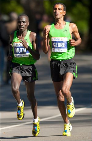 Ethiopia's Gebre Gebremariam, right, begins to pull away from Kenya's Emmanuel Mutai in Central Park. He won the race and took home $130,000.