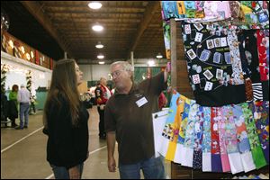 CTY craftshow08p  Laurie Lippert, of Erie, Michigam, left, speaking with Mike Metcalf, of Edgerton, Ohio about the 