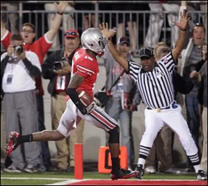 Ohio State defensive back Travis Howard picks off a Matt McGloin pass and returns it for a touchdown in the second half.