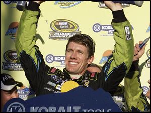 Carl Edwards holds up the trophy for winning Sunday's race at Phoenix International Raceway.