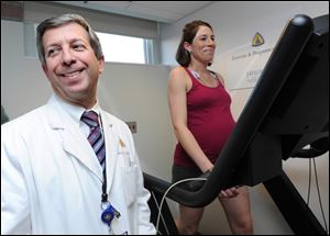 Dr. Andrew Satin monitors Meredith Dobrosielski's progress.