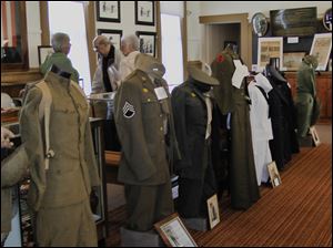 Uniforms stand at attention among other military items at the Oregon Jerusalem Historical Society museum's renovated room that opened on Veteran's Day.