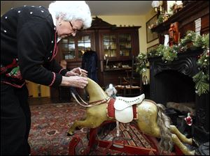 SLUG: CTY toys24p                    11/18/2010 The Blade/Amy E. Voigt               Maumee, Ohio  CAPTION:  Curator Marilyn Wendler adjusts the real horse hair on a rocking horse from about 1899 or 1900 on opening day for the Joys and Toys of Christmas Past at the Wolcott House Museum on November 18, 2010.