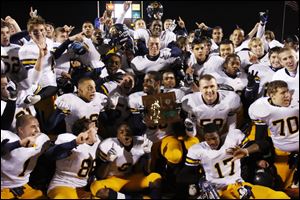 Whitmer celebrates as it receives the Division I regional championship trophy at BGSU's Perry Stadium.
