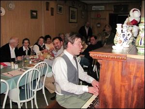 A co-owner of the Budapest, Rob McMahon, entertains the birthday celebrants.
