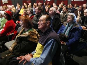 The crowd listens as Franklin Conaway, representing the Seneca County Courthouse and Downtown Redevelopment Group, makes a lengthy presentation about financing for the renovation project.