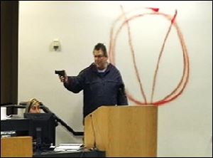 In an image taken from video, Clay Duke points a gun at Bay City school-board members and staff in Panama City, Fla., during their meeting Tuesday. The 56-year-old ex-convict shot at the superintendent of schools before killing himself. 