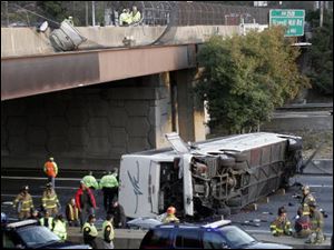 This March 2, 2007 photo shows a charter bus carrying the Bluffton  University baseball team after it plunged off a highway ramp in Atlanta, and slammed into the I-75 pavement below.