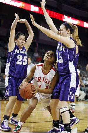 Ja'lyn Lathan of Central Catholic is trapped between Alyssa Palmer, left, and Alex Ferguson of Fremont Ross during the first game of the The Blade Classic at the Huntington Center. 
<br>
<img src=http://www.toledoblade.com/graphics/icons/photo.gif> <font color=red><b>VIEW GALLERY:</b></font> <a href=