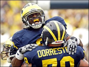 Martavious Odoms, left, will be back on the field for Michigan.