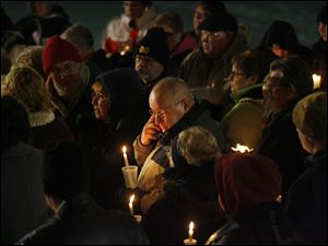 Slug:  CTY vigil23p  Date:  12232010      The Blade/Andy Morrison       Location: Adrian Caption: Don Zuvers, center, grandfather of the three Skelton boys, wipes away a tear during a vigil for three boys from Morenci who've been missing for nearly a month, at Trestle Park in Adrian, Thursday, 12232010. Summary: