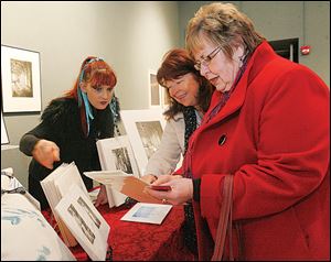 UT student Susan Mitchell, left, speaks with Kathy Shanteau and Pam Rehkopf at The University of Toledo Department of Art 