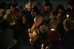 Slug:  CTY vigil23p  Date:  12232010      The Blade/Andy Morrison       Location: Adrian Caption: Don Zuvers, center, grandfather of the three Skelton boys, wipes away a tear during a vigil for three boys from Morenci who've been missing for nearly a month, at Trestle Park in Adrian, Thursday, 12232010. Summary: