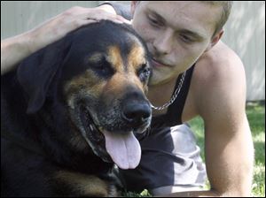 The  shooting of a dog, Tyson, allegedly by a neighbor, was one of many dog stories that made 2010 the Year of the Dog. He is here with his owner, Josh Luck. Other stories included the ongoing situation at the dog warden's office and additional incidences of animal cruelty.