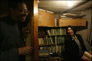 Robert Smith, president of the African American Legacy Project of Northwest Ohio, and Sheryl Riggs of Dale-Riggs Funeral Home look over records in the funeral home's basement. The want to put the information on the Web and in Legacy Project offices
