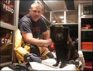 Washington Township firefighter Rob Bodi was among area rescuers who plucked this dog from ice on the Maumee River in December.