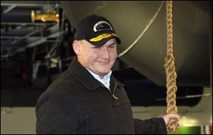 Pal LaMarre, executive director of the S.S. Willis Boyer, holds the rope that activates the horn that has been acquired by the Walleye.