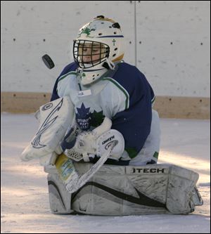 CTY roving10p 1/9/11  The Blade/Dave Zapotosky Jack Regan, goalie for the Sylvania Maple Leafs Pee Wee A-1999 hockey team, stops a shot on goal by the Novi, Michigan Ice Cats during the Winter Chill Outdoor Festival at Ottawa Park Ice Rink, Sunday, January 9, 2011. 47 hockey teams played 28 games during the festival which ran fromThursday through Sunday. Teams from Pennsylvania, Indiana, Michigan, and Ohio, ranging in age from 8-17, participated in the event.