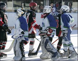 CTY roving10p 1/9/11  The Blade/Dave Zapotosky Players from the Sylvania Maple Leafs Pee Wee A-1999 hockey team front, shake hands with players from the Novi, Michigan Ice Cats following their game during the Winter Chill Outdoor Festival at Ottawa Park Ice Rink, Sunday, January 9, 2011. 47 hockey teams played 28 games during the festival which ran fromThursday through Sunday. Teams from Pennsylvania, Indiana, Michigan, and Ohio, ranging in age from 8-17, participated in the event.