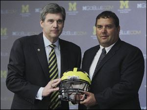 University of Michigan Athletic Director Dave Brandon, left, stands with new head football coach Brady Hoke.