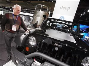 Bruce Baumhower admires a Jeep Wrangler Call of Duty edition. Tuesday's visit to the auto show was his first in more than a decade, but in one vehicle after another, his reaction was the same. 'Wow. Just wow.'
