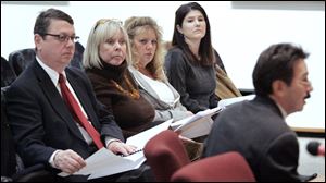 Rob Ludeman, left, Carol Dunn, Debbie Johnson, And Tara Kestner, members of the advisory committee listen as chairman Steve Serchuk explains the 15 recommendations. The group plans to meet next month and then once a year.