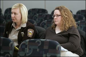 Dog Warden Julie Lyle, right, with assistant Jessica Poupard, hears the panel's findings. Ms. Lyle said many of the changes for her department are in the works.