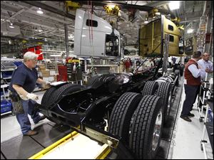 In Dublin, Va., a chassis rolls along the Volvo truck assembly line. Orders for goods such as machinery increased 1.4 percent in December after a 3.1 percent rise in November, government reports said.