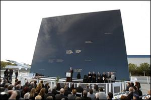 Stephen Feldman, at podium, president and CEO of the Astronauts Memorial Foundation speaks in front of the memorial during a rememberance ceremony to mark the 25th Anniversary of space shuttle Challenger explosion at the Kennedy Space Center visitor complex in Cape Canaveral, Fla., Friday.