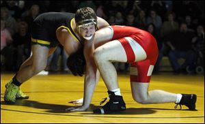 Clay's Garrett Gray, left, takes down Central Catholic's Levi Pickerel in overtime of their 285-pound match. Gray secured the 5-3 victory when Pickerel slipped while trying a roll move.