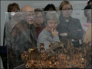 Marion and Ellen Steiner of Temperance, at front and center, tour the Aminah Robinson exhibit at the Glass Pavilion of the Toledo Museum of Art. Marion has memory loss and is touring with others who have the same difficulty.