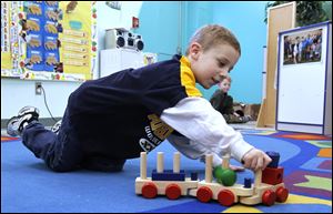 Michael Fitch, Jr., plays at the East Toledo Family Center, which his father attended about 25 years ago. The center offers a variety of educational, social service, and recreational programs. 