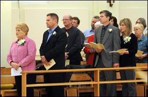 Brother Francis' mother, Judy Wagner, left, his brother Kevin Wagner, his cousin Tim Hahn (to the right of Kevin Wagner and in the row behind), his brother-in law Ty Snodgrass, and his sister Shannon Snodgrass witness the ceremony at St. Meinrad's.