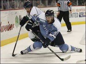 Florida's Francis Lemieux, left, and Toledo's Sebastien Piche chase the puck in the second period.