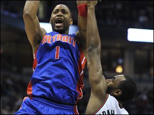 Detroit's Tracy McGrady, taking a shot over Milwaukee's Luc Richard Mbah a Moute, has changed his approach from looking to be an elite scorer to being a point guard.