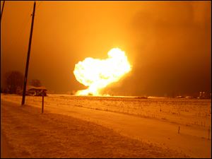 Burning ethanol lights the sky in Cass Township, just west of Arcadia, Ohio. Twenty-six train cars jumped the tracks, and the contents of those that ruptured caught fire.