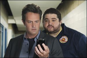 Ben Donovan (Matthew Perry), left, and Robert the maintenance man (Jorge Garcia) get notice of another emergency at the sports arena where they work in 'Mr. Sunshine.'